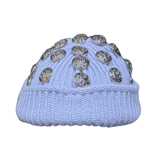 Light blue knit beanie with decorative buttons on a white background